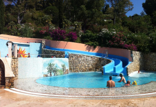 Water park with a blue water slide and pool at Campsite Rosselba le Palme in Tuscany, Italy.