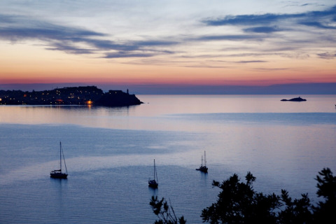 Evening sea view with sailboats near the coast, photographed at Campsite Rosselba le Palme in Tuscany, Italy.