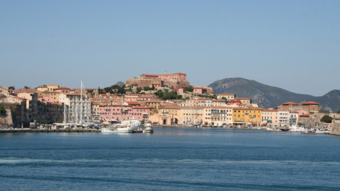 View of the harbor and colorful buildings from Campsite Rosselba le Palme holiday park in Tuscany, Italy.