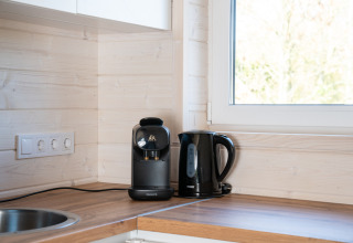Macchina da caffè e bollitore elettrico su piano di legno nella cucina luminosa di Slowlodge 2, Zomerlicht, Paesi Bassi.