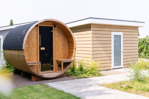 Buitenzicht op een barrelsauna en modern tuinhuis bij Resort Mooi Bemelen in Nederland.