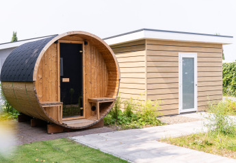 Udendørs billede af en tøndeformet sauna og moderne havehus ved Resort Mooi Bemelen i Holland.