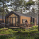 Alojamiento glamping moderno en el bosque, personas desayunando en la terraza, rodeados de naturaleza.
