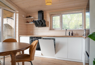 Moderne lichte houten keuken in Slowlodge bij Zomerlicht, Nederland, met veel natuurlijk daglicht.