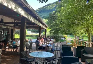 Terrazza esterna del campeggio La Prade in Occitania, Francia, immersa nel verde e nella natura.