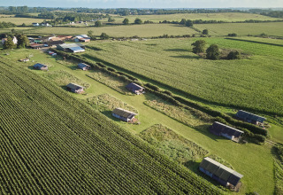 Aerial view of BoerenBed College Farm holiday park in East of England, with lodges and green fields.