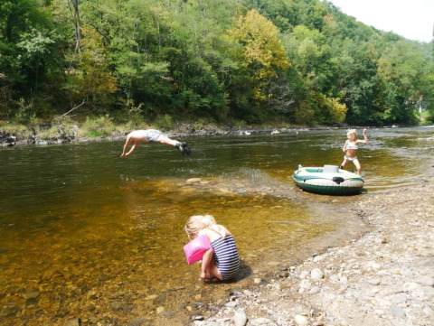Bambini giocano vicino al fiume al campeggio Les Terrasses de Dordogne in Nouvelle-Aquitaine, Francia.