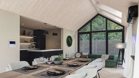 Moderne, lyst lodgeinteriør med stort vindue, spisebord, køkken og grøn sofa på Estate De IJsvogel.