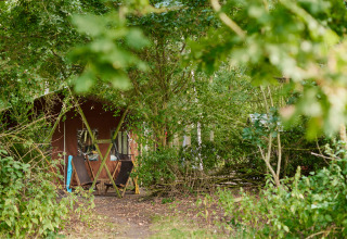 A cozy cabin hidden among green trees at BoerenBed Layer Marney Tower holiday park in East of England.