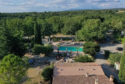 Holiday park in Provence-Alpes-Côte d’Azur, France, with pool surrounded by lush trees and nature.