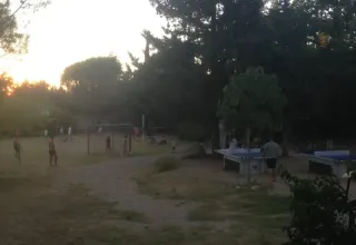 Children playing football and table tennis at sunset at Campsite Avelanède in Provence-Alpes-Côte d’Azur, France.