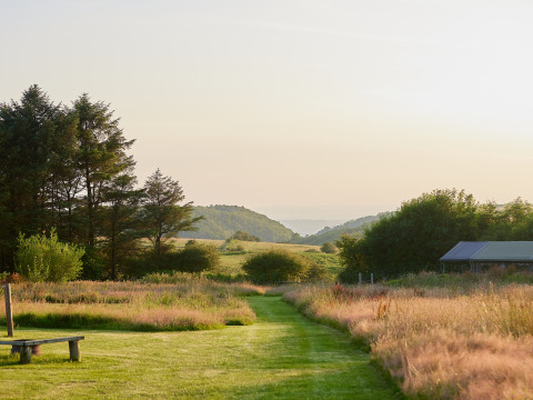 Vista del paisaje al atardecer en BoerenBed Warren Farm, un parque vacacional en el suroeste de Inglaterra, Reino Unido.