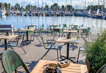 Caffetteria all'aperto con vista sul porto turistico di Marina Parcs Naarden nei Paesi Bassi, giornata soleggiata.