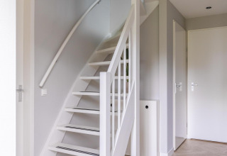 Bright, modern staircase at Ecovilla Waterzicht Comfort, Holiday park Latour, The Netherlands.