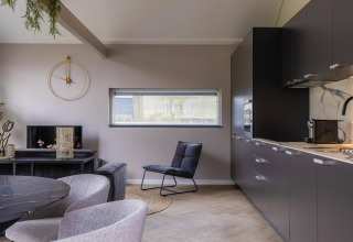 Modern living room and kitchen at Ecovilla Waterzicht Comfort, Holiday park Latour, Netherlands, stylishly furnished.
