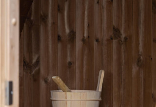 Cubo de madera y cucharas dentro de una sauna en Ecovilla Waterzicht Comfort Sauna & Buitendouche, parque Latour.