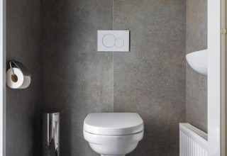 Modern wall-mounted toilet in a bathroom at Villa Bosrand Comfort, Holiday park Latour, Netherlands.