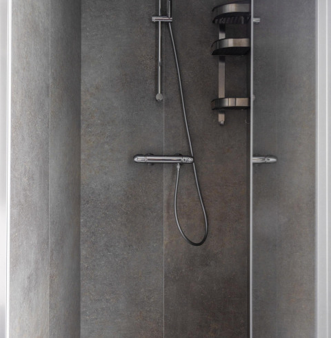 Modern shower with grey tiled walls, chrome shower head, and shelf at Villa Bosrand Comfort, Latour, NL.