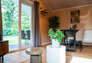 Modern interior at Lodge Deluxe, Holiday park Latour in the Netherlands, with garden view and sunlight.