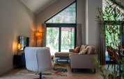 Bright, modern living room at Ecovilla Waterzicht Luxe, Holiday park Latour in the Netherlands, with forest view.