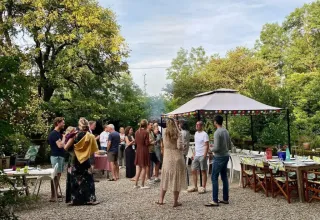 Sommerliche Gartenparty im Les Savonniers Ferienpark, Occitanie, Frankreich mit Gästen und Pavillon.