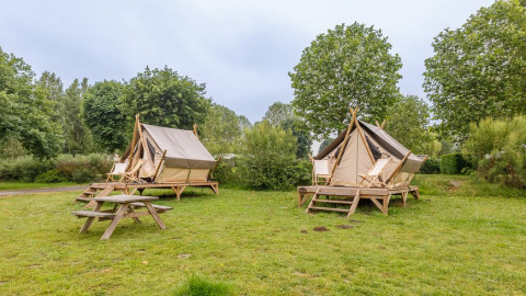 Twee Bivouac safaritenten op Camping Seasonova Lac de Bournazel in Frankrijk, met omliggend groen.