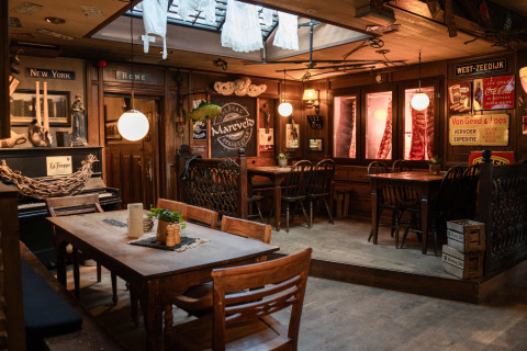 Cozy vintage dining area at Campsite Mareveld holiday park in Limburg, Netherlands, with rustic decor.