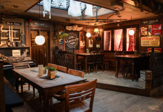 Cozy vintage dining area at Campsite Mareveld holiday park in Limburg, Netherlands, with rustic decor.