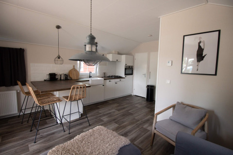 Contemporary lodge kitchen and seating area at Luxe Chalet in Campsite Mareveld, Netherlands.