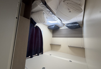 Interior view of a modern cabin named Cottage at Campsite Seasonova Ensoya, France, with bed setup.