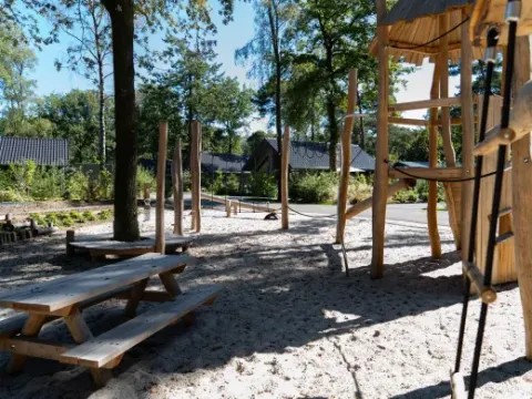 Playground with wooden structures and picnic tables at Holiday park Latour, North-Brabant, Netherlands.