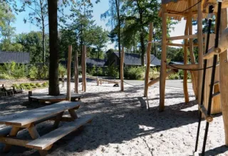 Playground with wooden structures and picnic tables at Holiday park Latour, North-Brabant, Netherlands.