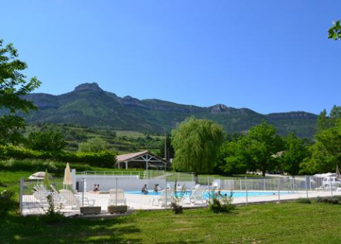 Scenic view of Onlycamp Camping Les Tuillères in Auvergne-Rhône-Alpes, France, showing pool and mountains.