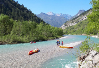 Folk padler i kajakker på en flod omgivet af bjerge og skov nær Vercheny i Auvergne-Rhône-Alpes, Frankrig.