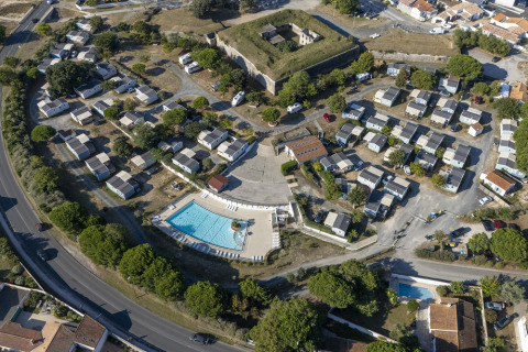 Aerial view of Flower Camping Le Platin - La Redoute holiday park with pool and cabins on Île de France.