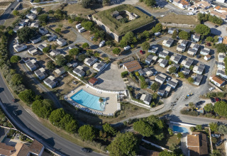 Aerial view of Flower Camping Le Platin - La Redoute holiday park with pool and cabins on Île de France.