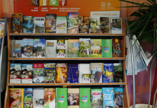 Brochure stand featuring info about Citadelle Besançon and attractions at Camping de Besançon, France.