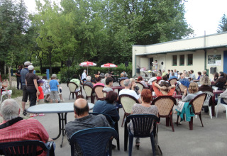 People gathered outdoors at an event in Onlycamp Camping de Besançon, Bourgogne-Franche-Comté, France.