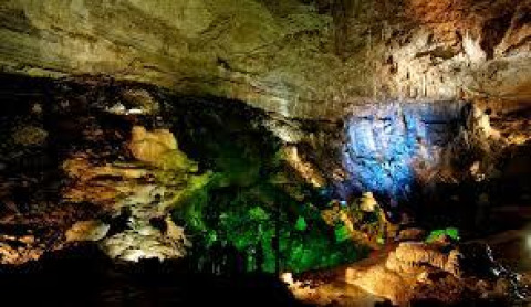Vividly lit cave interior at Onlycamp Camping de Besançon, a holiday park in Bourgogne-Franche-Comté, France