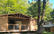 Cottons Flower Comfort safari tent at Flower Camping Le Platin - La Redoute in France, surrounded by trees.