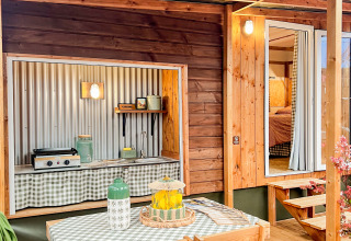Wooden outdoor dining setup at Karlotte Zeezicht Premium, Flower Camping Le Platin - La Redoute, France.