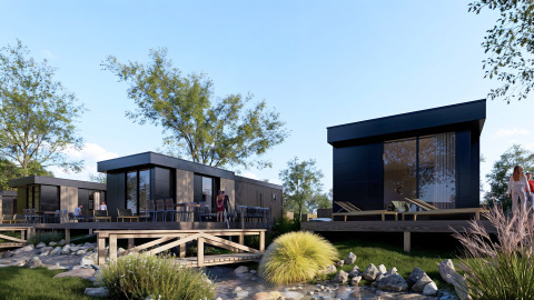 Modern cabins with outdoor decks by a pond at Valkhof met Hottub lodge in Veluwe park de Bosgraaf, Netherlands.
