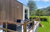 Outdoor terrace with black garden furniture at Eco Lodge MOBLINA, Campsite Floreal La Roche-en-Ardenne, Belgium.