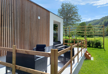 Buitenterras met zwarte tuinmeubels bij Eco Lodge MOBLINA, Camping Floreal La Roche-en-Ardenne, België.
