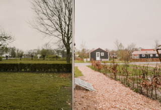 Casa espejo en Holiday park Eigen Wijze, Países Bajos, refleja la naturaleza y casas pequeñas.