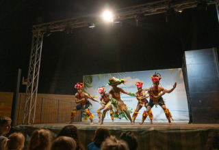 Polynesian dance performance at Sandaya Etruria holiday park in Tuscany, Italy, in front of a lively audience.