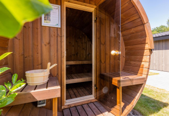 Outdoor round wooden sauna at Villa Waterzicht Luxe with Sauna, Holiday park Molenvelden, Netherlands.
