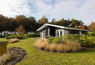 Moderne villa med have og søudsigt i ferieparken Molenvelden, Nederlandene, omgivet af natur.