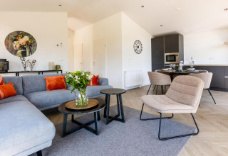Chic living and dining area in Villa Waterzicht Luxe met Ligbad at Holiday park Molenvelden, Netherlands.