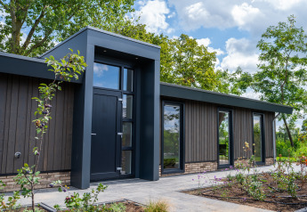 Modern lodge at Villa Veldzicht, Holiday park Molenvelden in the Netherlands, with nature and landscaped garden.